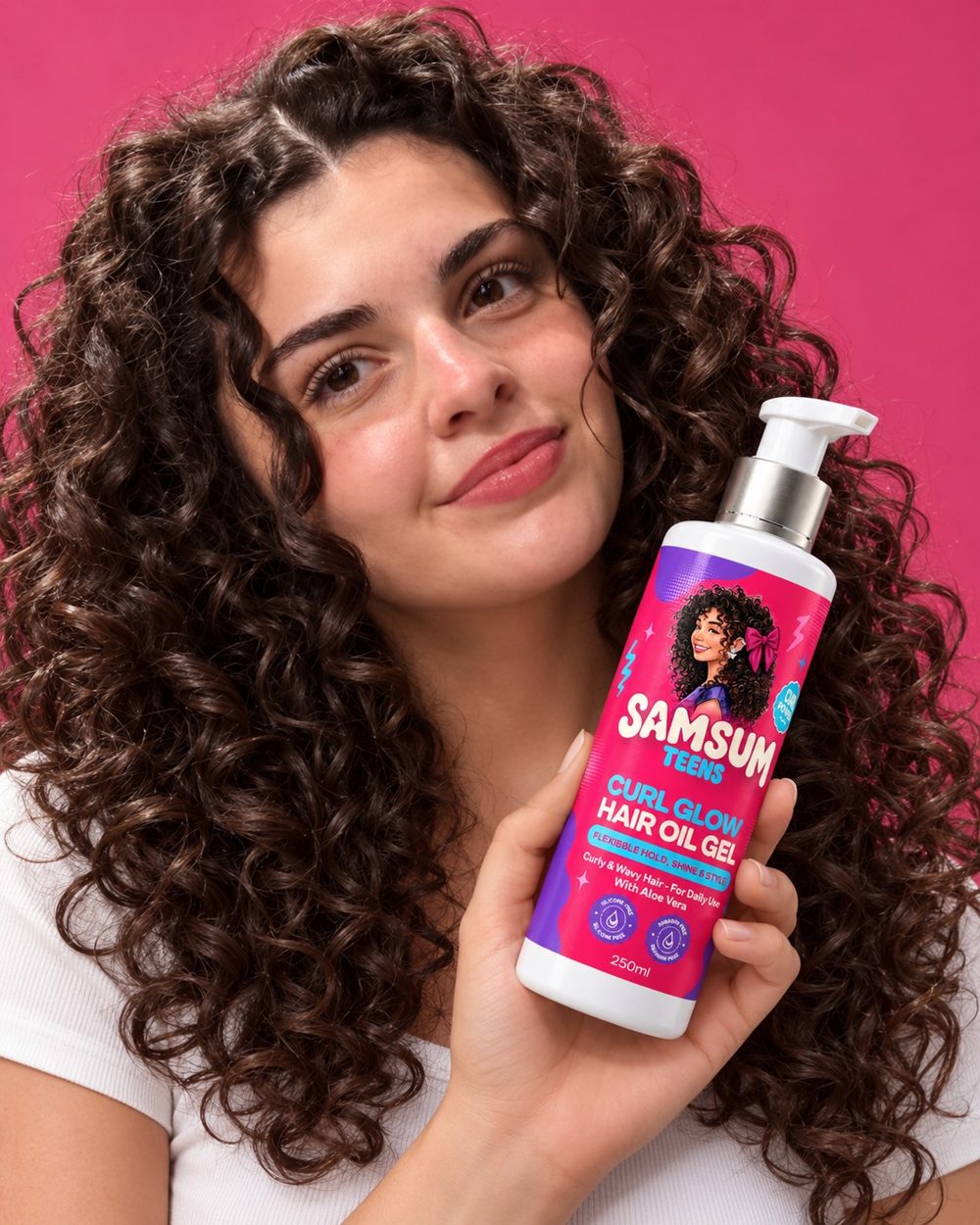 Girl with long curls holding Samsum Teens Curl Glow Hair Oil Gel